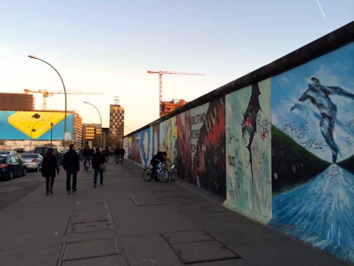 People passing by the East Side Gallery in Berlin